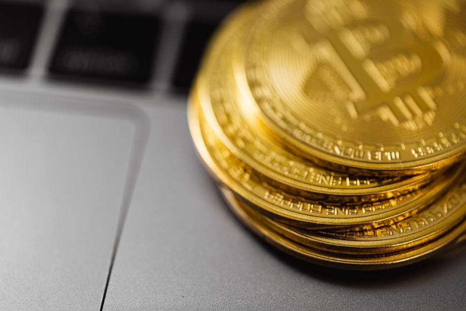 Stack of gold Bitcoin coins representing Bitcoin vs ETF long term investment comparison