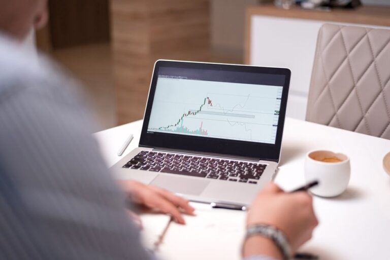 Trading laptop with coffee on desk comparing DEGIRO vs Interactive Brokers online broker platforms