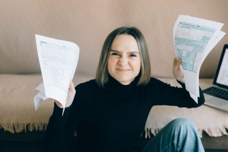 Frustrated person surrounded by Austrian tax paperwork and ETF investment documents at a desk