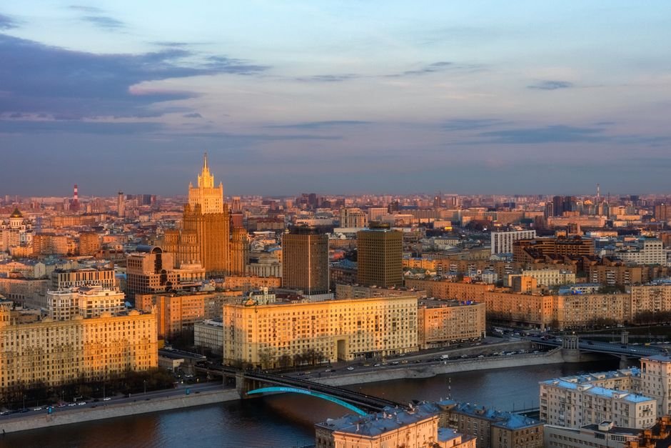 Eastern Europe city skyline with modern financial district and stock market data overlay