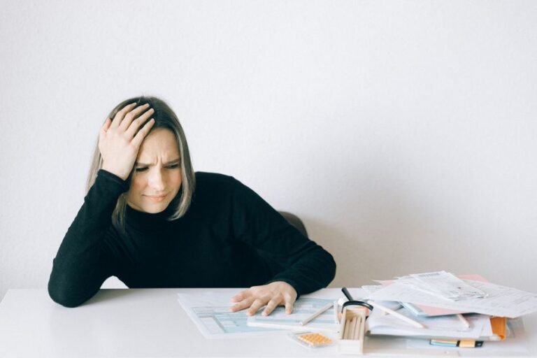Stressed German taxpayer surrounded by tax paperwork and Freistellungsauftrag forms