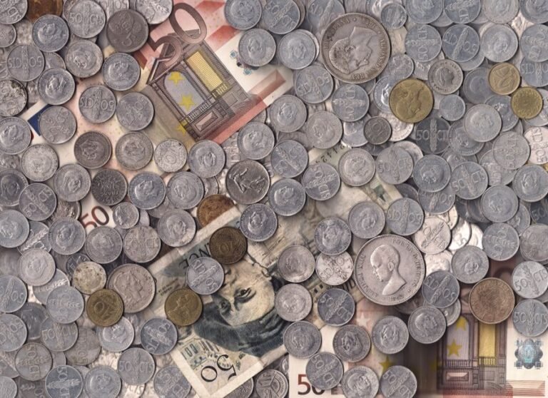 European flags and investment coins arranged together, representing ISA equivalent investment opportunities across Europe