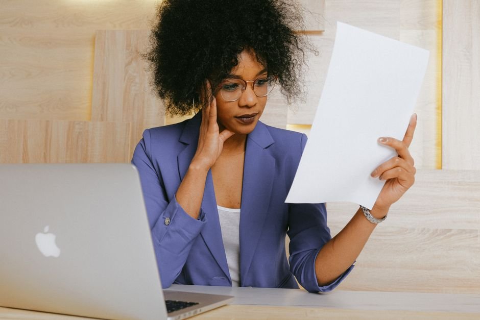 Confused investor reading a KIID ETF document with complex financial charts