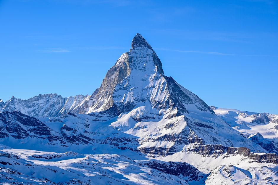 Swiss Alps mountain peaks with stock market chart overlay representing the best broker Switzerland options