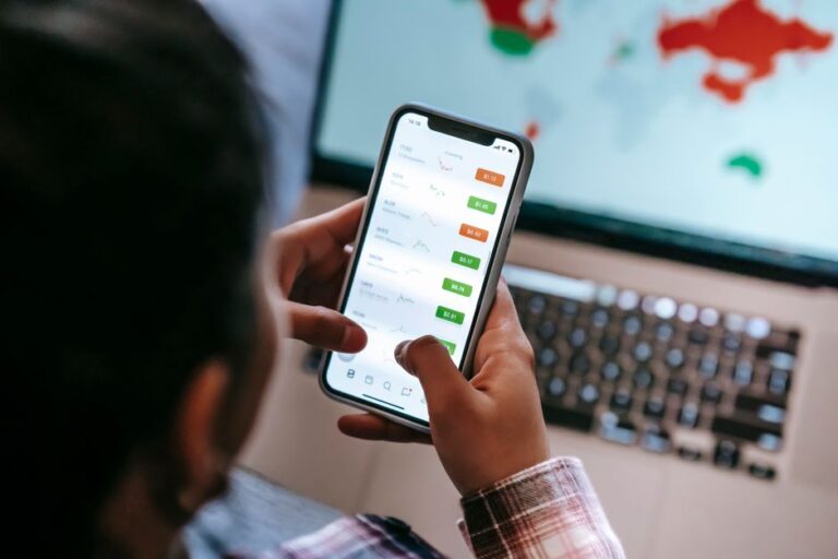Person checking phone stocks and investment portfolio on the best investing app Europe 2026