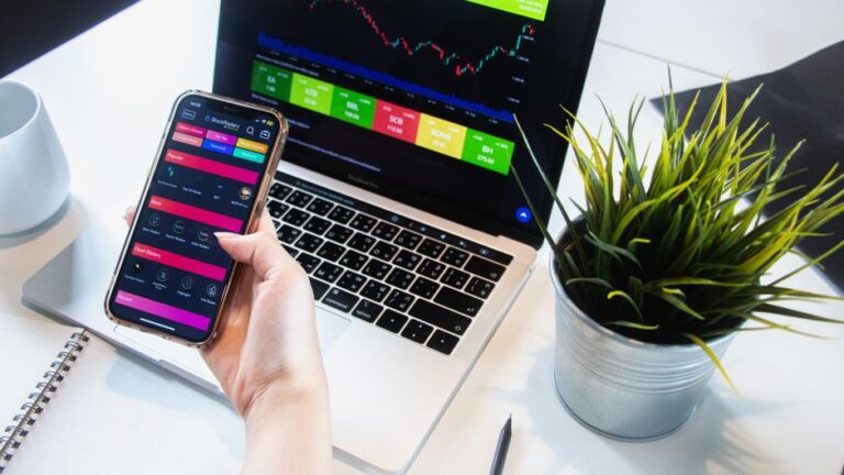 Hands holding a smartphone displaying a stock trading app for buying fractional ETFs in Europe