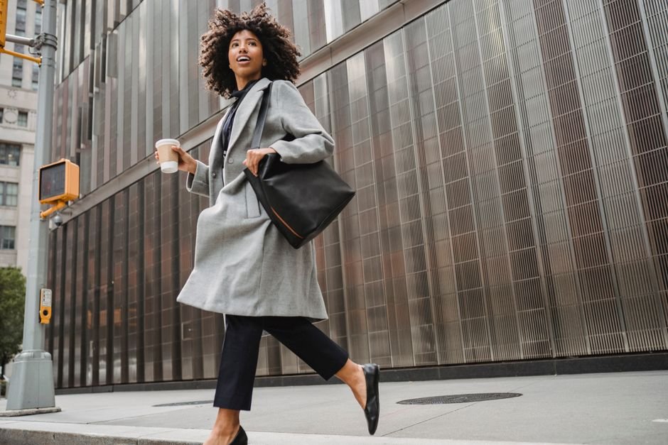 Person walking away from office building toward financial independence in Europe