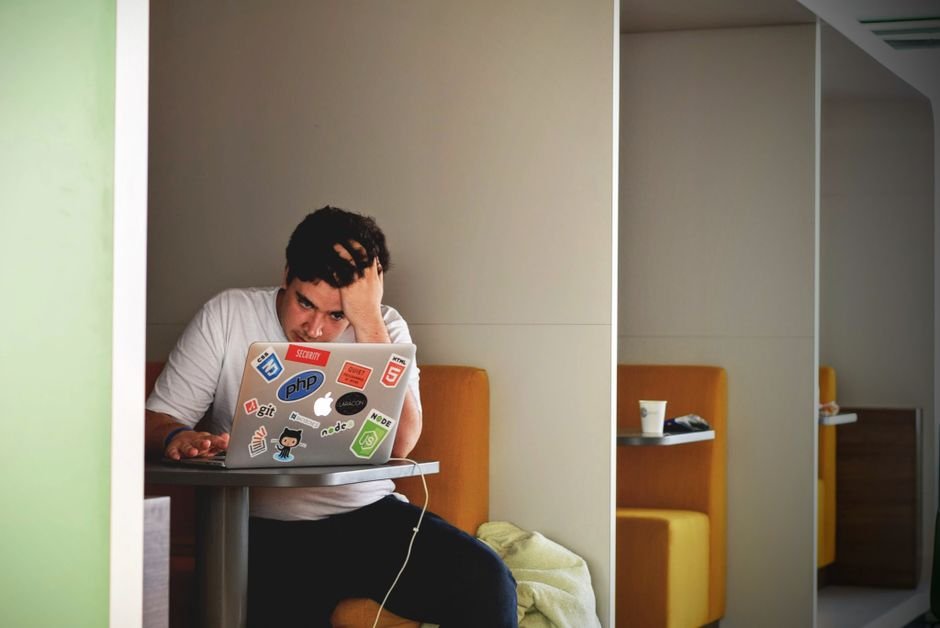 Worried young European professional checking retirement savings and investments on laptop screen