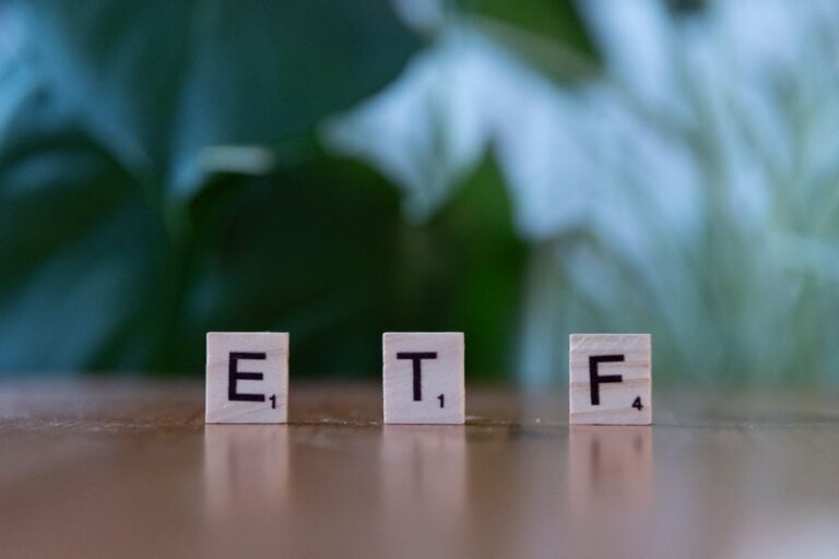 Austrian investor researching ETF investments on laptop at home office desk