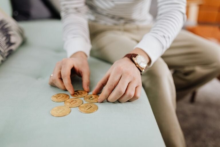 Person counting coins for smart investing on a budget in Europe
