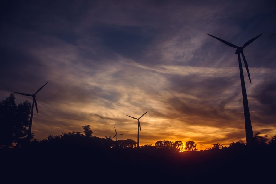 Wind turbines at sunset in Europe representing sustainable ETF investment opportunities