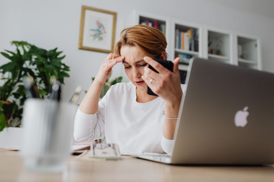 Worried investor checking phone while deciding when to sell ETF Europe holdings